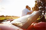 Couple sitting on electric sports car