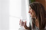 Woman drinking water at home