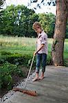 Boy sweeping the porch