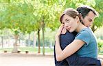 Couple embrace in park in Paris