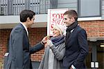 Couple receiving keys from estate agent