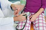 Doctor testing childs blood pressure