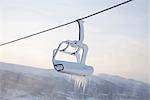 Chair lift full of snow and ice