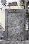 Madeira. blocked doorway with number 121 and paint peeling off wall