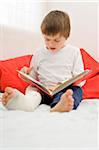 Boy with Cast on Leg Looking at Book