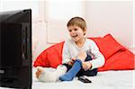 Boy with Cast on Leg Watching TV and Putting on Sock