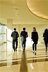 Executives walking in lobby, rear view