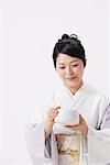 Woman In Kimono Holding Japanese Tea Cup