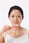 Portrait Of Woman Holding Toothbrush