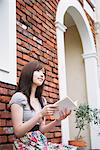 Beautiful Teenage Girl Sitting And Holding Book