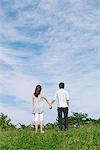 Couple debout dans le parc, main dans la main