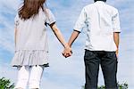 Midsection of Couple Standing Holding hands