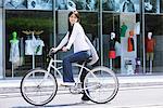 Young Woman  on Cycle outside Shopping Store