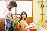 Hairdresser Cutting Hairs of Client