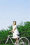 Japanese Young Woman with Bicycle in Park