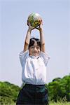 Boy Playing with Globe Ball