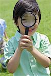 Japanese Boy Looking from Magnifying Glass