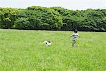 Boy Running in Park with his Pet