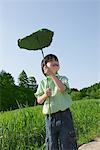 Boy Standing Holding Leaf