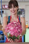 Florist holds out pink hydrangea