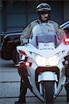 Patrol officer sits on motorcycle with hazrd lights lit