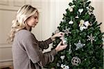 Woman Decorating Christmas Tree