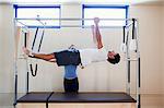 Man doing pilates with instructor