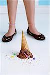 Dropped Chocolate Ice Cream Cone Upside Down on Floor at Girl's Feet