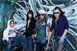 Group of Young Teens Standing in front of Graffiti Covered Wall