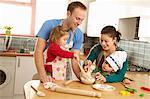 Young family cooking together in kitchen