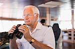 Captain on ship holding  a telescope