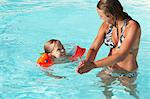 Mother and son playing in swimming pool