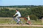 Father and son on bicycle in the fields
