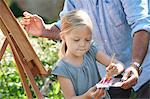 Grandfather and granddaughter painting