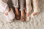 Close-up of three females in slippers