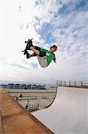 Asian skateboarder doing flip trick