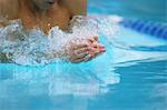 Young adult man swimming in swimming pool