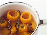 Cooking the yellow tomatoes with oranges and spices