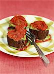 Sliced eggplant stuffed with greens and confit tomatoes