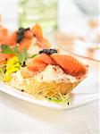 King crab,mayonnaise,salmon and caviar on a bite-size slice of bread