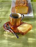 Cup of coffee and a slice of orange-flavored sponge cake