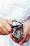 Person opening an oyster