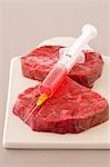 Raw red meat with hormones