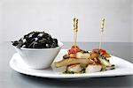 Pan-fried scallops and squid with squid ink tagliatelles