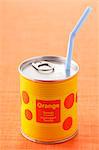 Straw in a can of orange juice