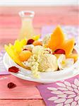 Melon and mango fruit salad with vanilla ice cream