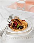 Rolled pancake filled with summer fruit