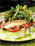 Baked sea bream with tomato and rocket salad