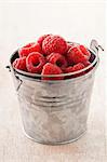 Small metal bucket of raspberries