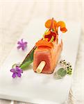 Teriyaki salmon brochette with edible flowers